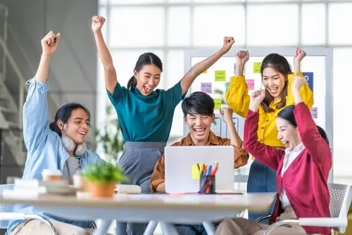 Professional diverse team posing together in modern office environment